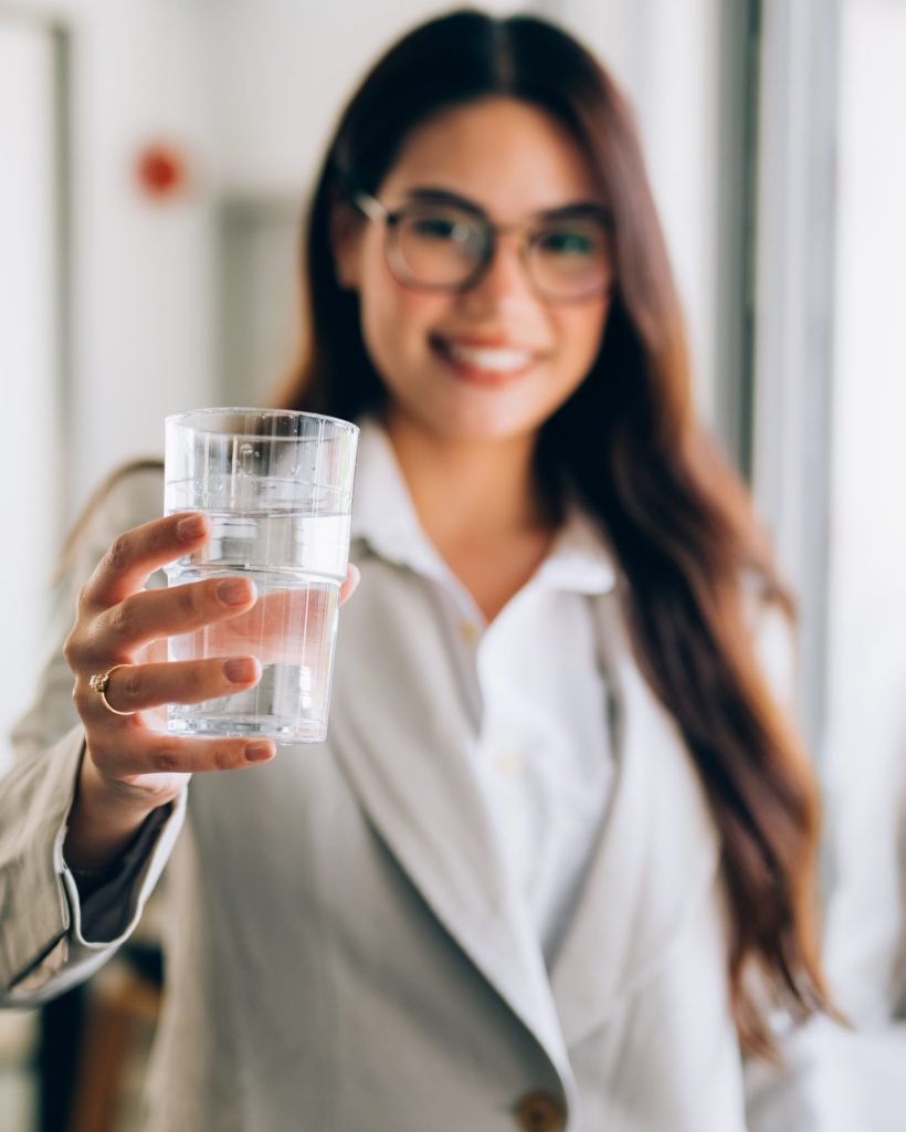 Confident businesswoman with glass at office, Profession female manager drinking water with happiness, High quality photo